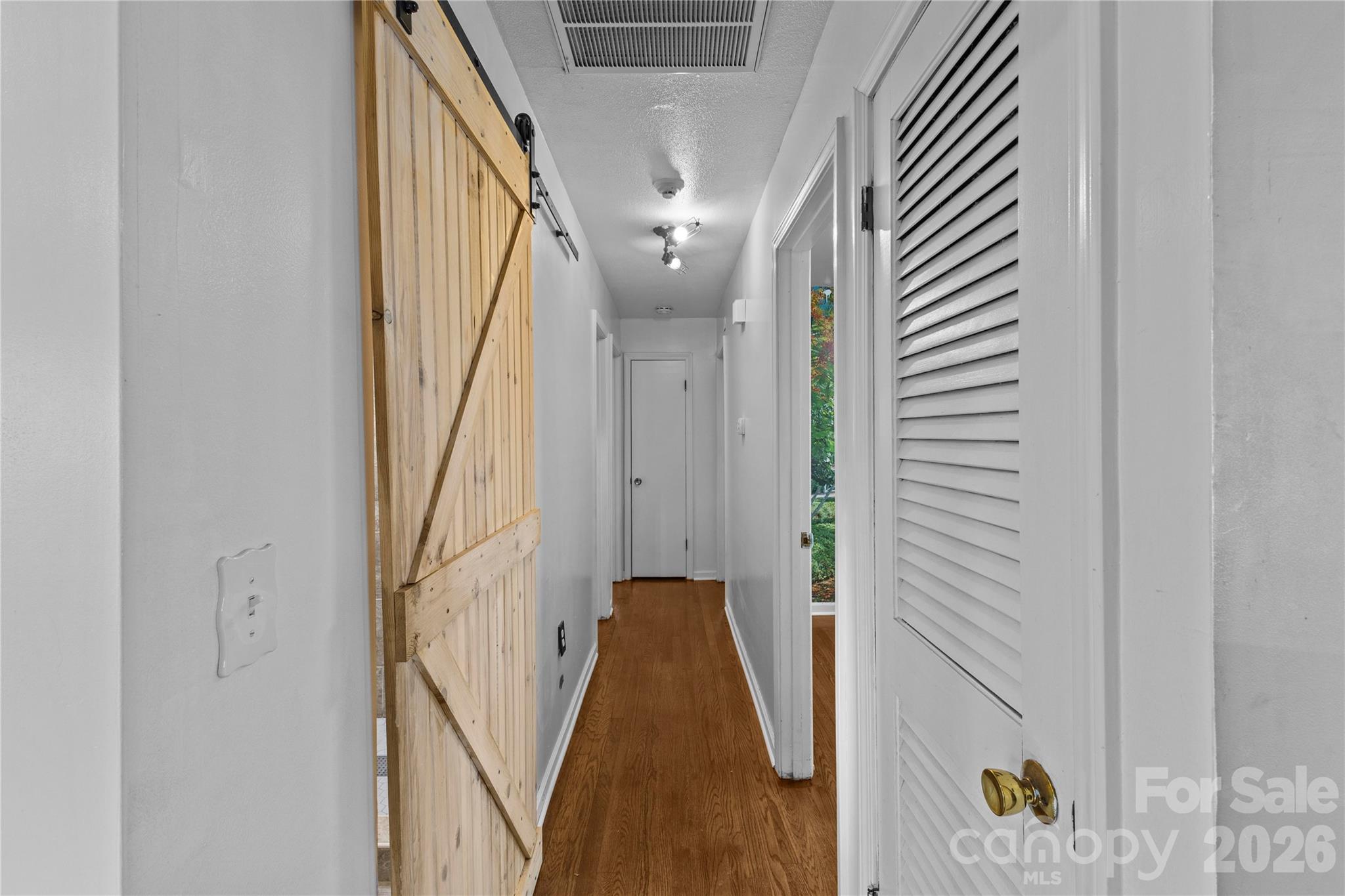 117 Robinson Avenue Matthews, NC 28104 - Photo 11 of 42 a view of a hallway with wooden floor and staircase