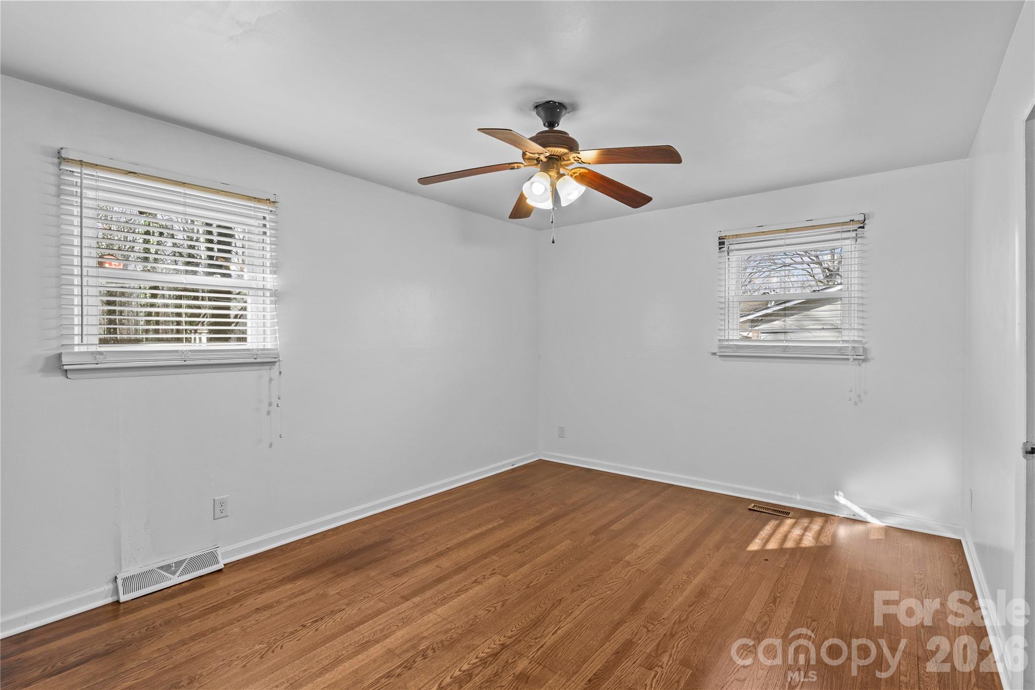 117 Robinson Avenue Matthews, NC 28104 - Photo 14 of 42 a view of empty room with wooden floor and fan