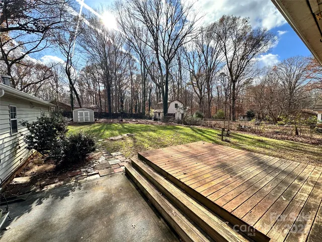 a view of a backyard with large trees