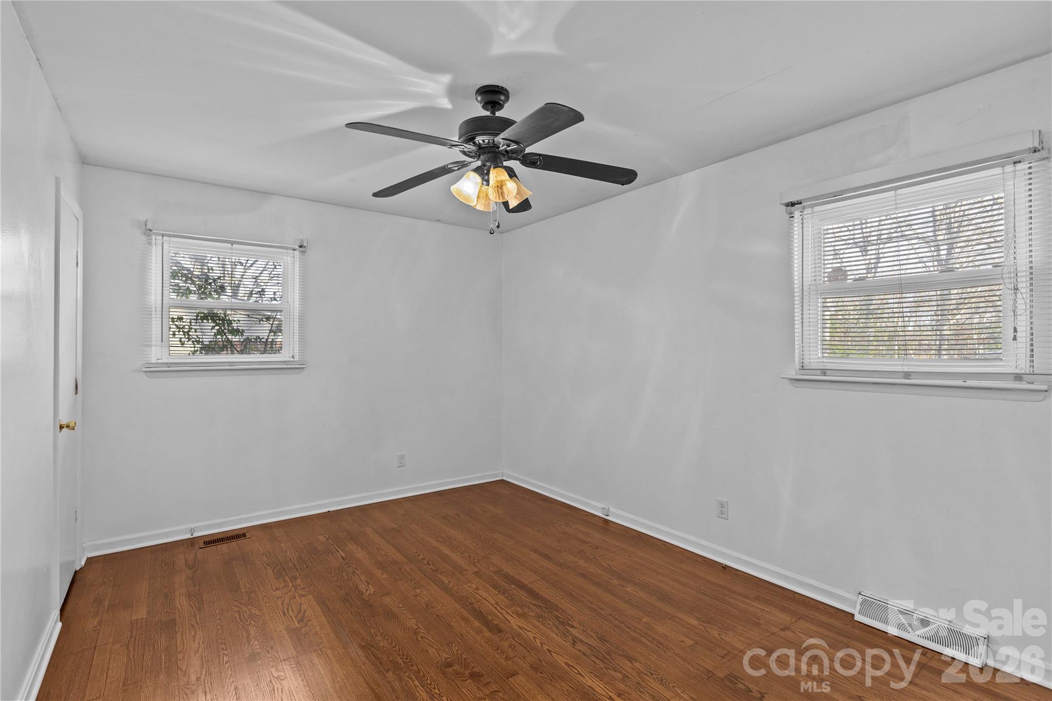 117 Robinson Avenue Matthews, NC 28104 - Photo 19 of 42 a view of empty room with wooden floor and fan