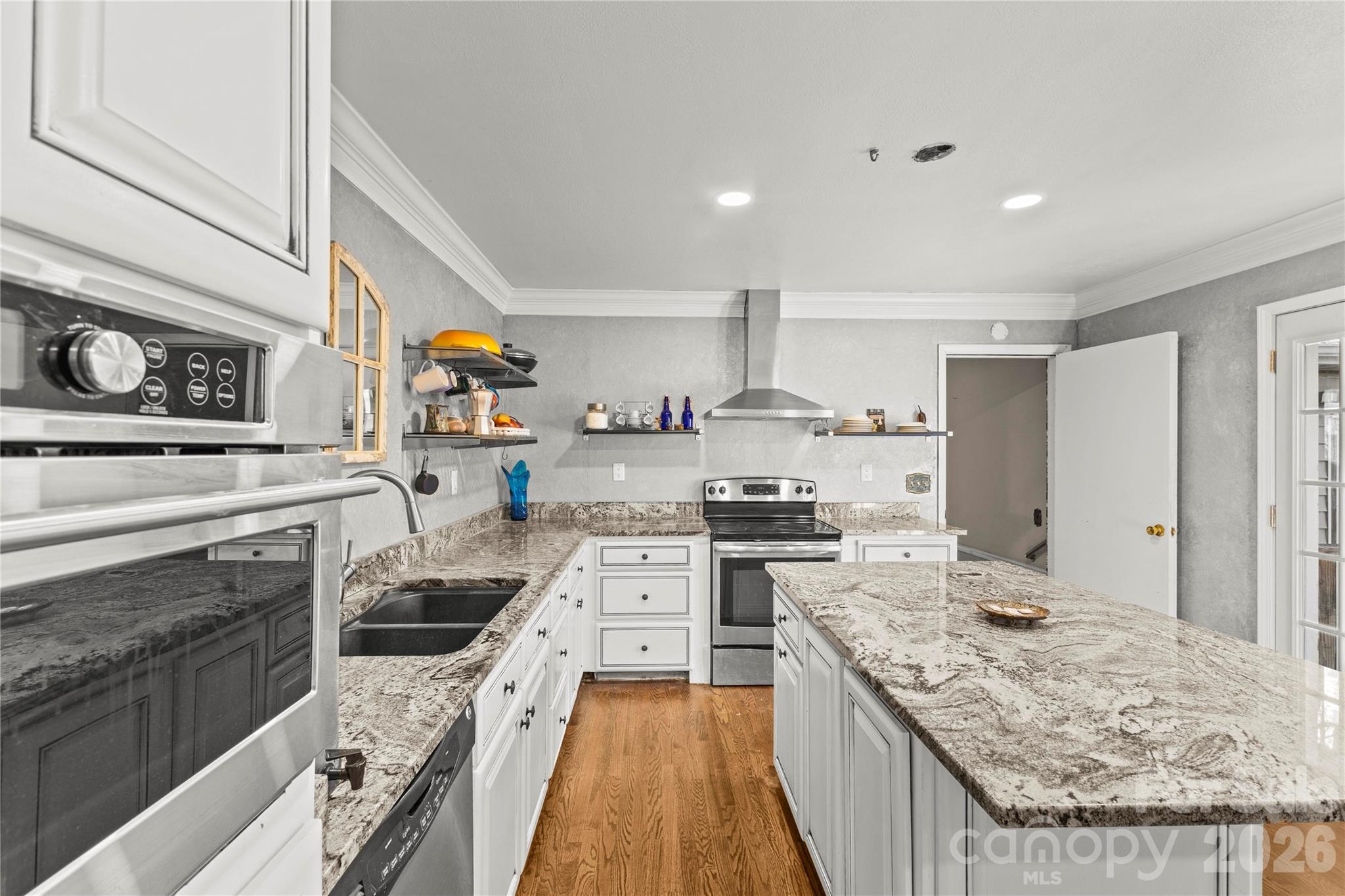 117 Robinson Avenue Matthews, NC 28104 - Photo 3 of 42 a kitchen with stainless steel appliances granite countertop a stove oven and a white cabinets