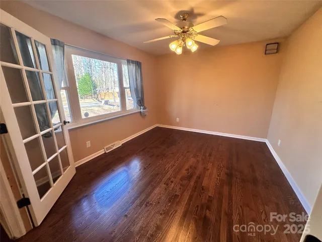 wooden floor in an empty room with a window