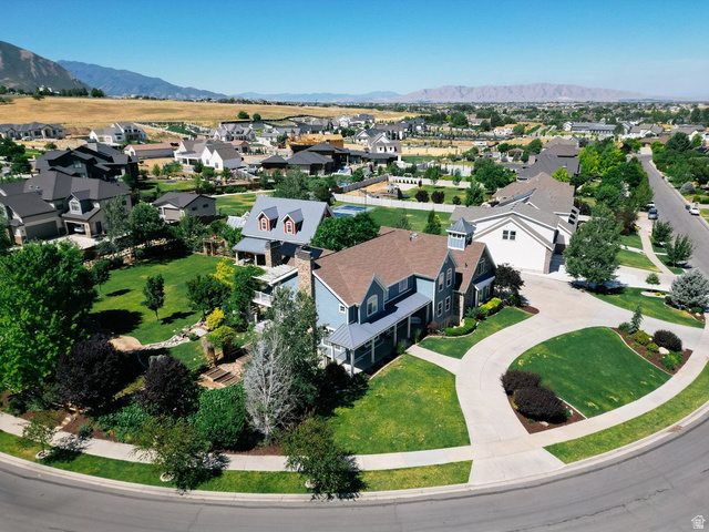672 Perry Hollow Drive Mapleton, UT 84664 - Photo 13 of 106 Expansive corner lot with a distinctive two-story residence, featuring a two-car garage, mature landscaping, and an extended driveway