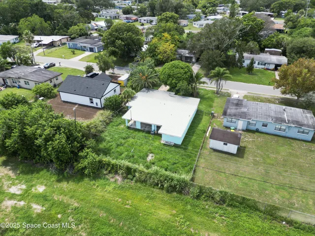 an aerial view of a house with swimming pool outdoor seating and yard