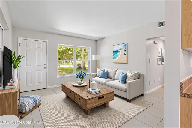 a living room with furniture and a large window