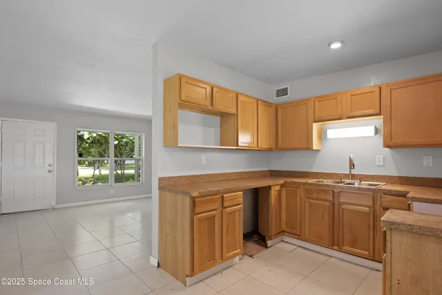 a kitchen with a sink cabinets and window