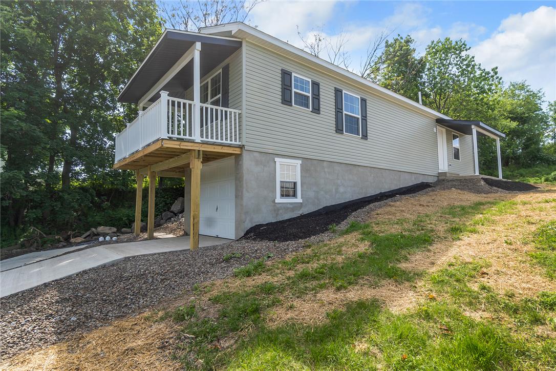 624 Main Road Lehighton, PA 18235 - Photo 8 of 42 A well-maintained facade with an elevated balcony and convenient garage access below.