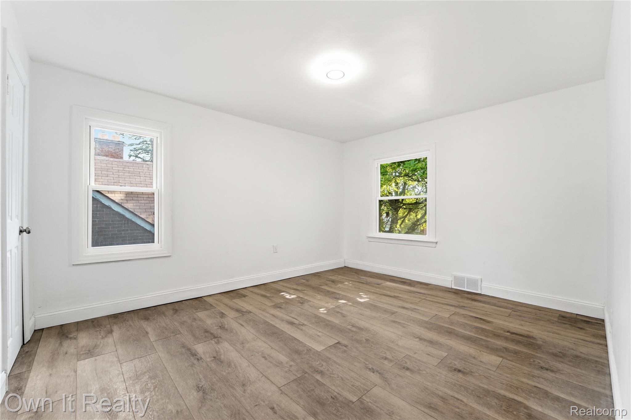 17351 Appoline Street Detroit, MI 48235 - Photo 27 of 34 Neutral white walls featuring wood-finish flooring and white baseboards