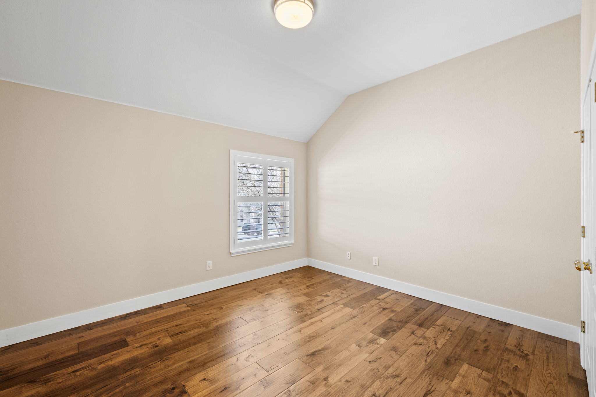 8112 Cobblestone Austin, TX 78735 - Photo 29 of 33 Unfurnished room featuring lofted ceiling and hardwood / wood-style floors