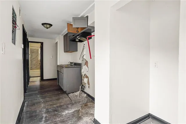 a kitchen with stainless steel appliances granite countertop a sink and a refrigerator