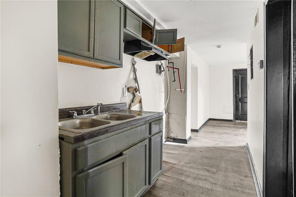 420 Griffin Street Northwest Atlanta, GA 30318 - Photo 12 of 40 a kitchen with stainless steel appliances granite countertop a sink and a refrigerator