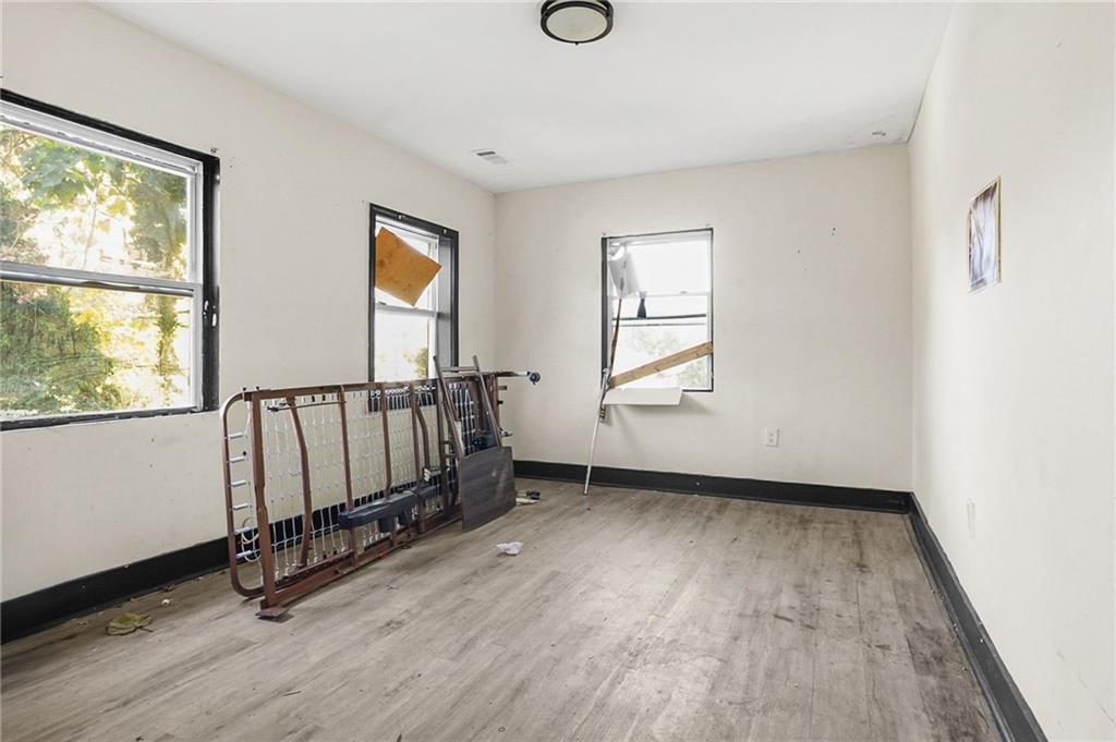 420 Griffin Street Northwest Atlanta, GA 30318 - Photo 14 of 40 an empty room with wooden floor and windows