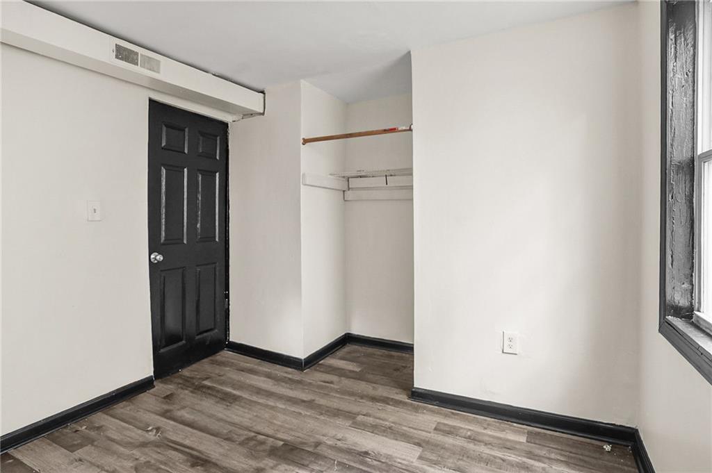 420 Griffin Street Northwest Atlanta, GA 30318 - Photo 18 of 40 a view of an empty room with wooden floor and closet