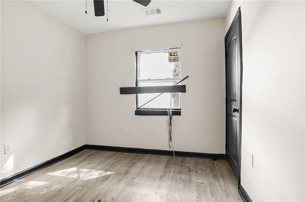 420 Griffin Street Northwest Atlanta, GA 30318 - Photo 19 of 40 a view of an empty room with wooden floor and a window