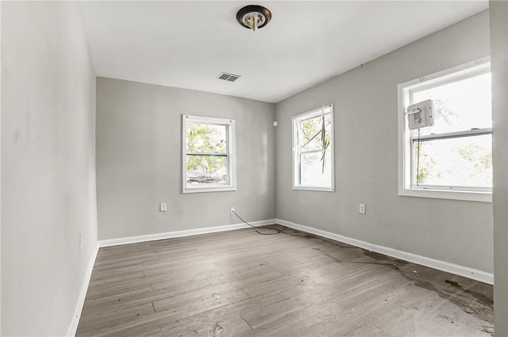 420 Griffin Street Northwest Atlanta, GA 30318 - Photo 23 of 40 a view of empty room with wooden floor and fan