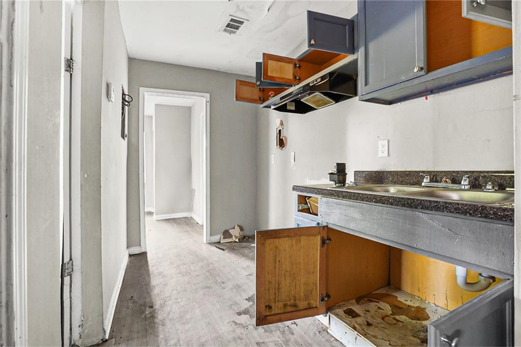 420 Griffin Street Northwest Atlanta, GA 30318 - Photo 26 of 40 a kitchen with a refrigerator and cabinets
