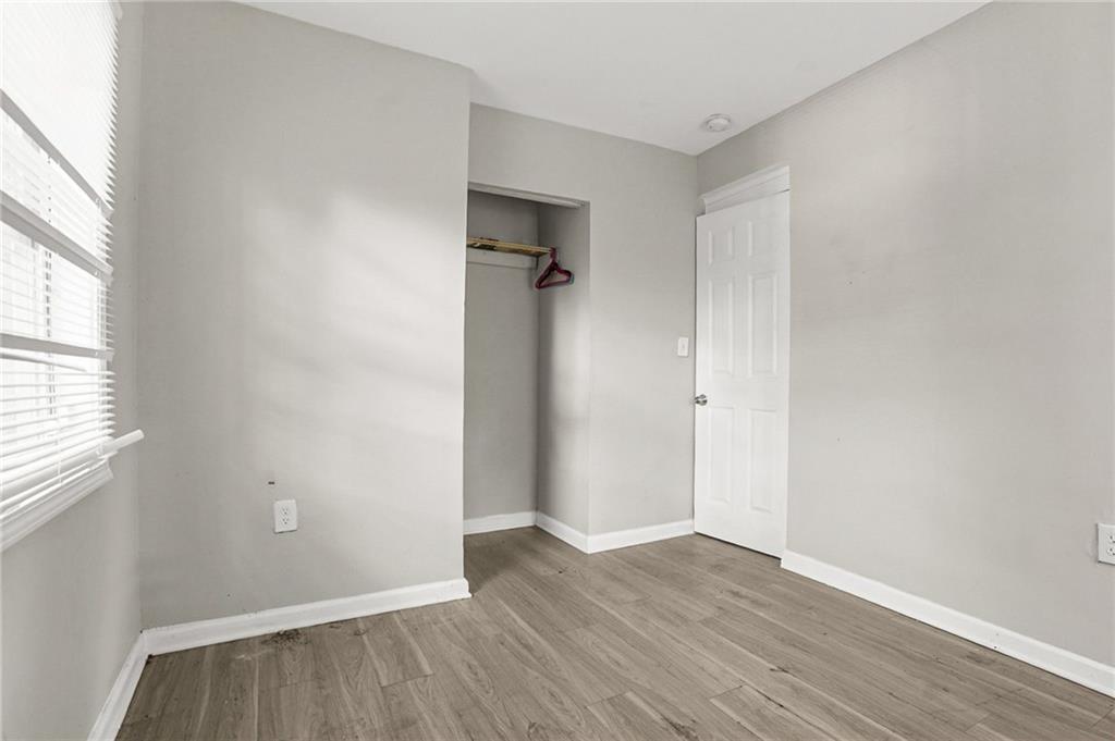 420 Griffin Street Northwest Atlanta, GA 30318 - Photo 27 of 40 an empty room with wooden floor and a window