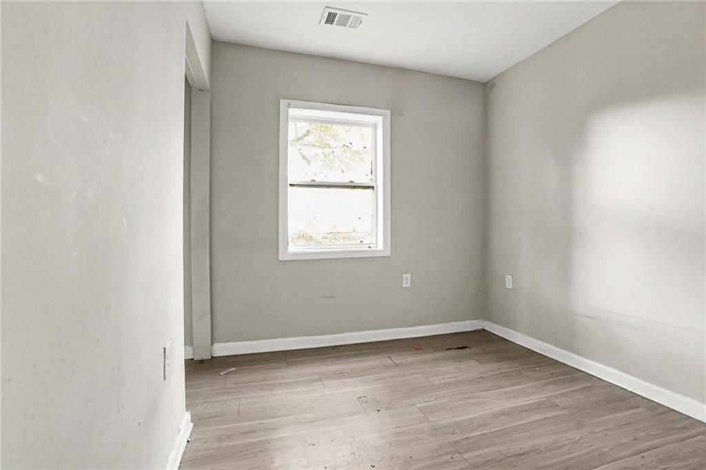 420 Griffin Street Northwest Atlanta, GA 30318 - Photo 28 of 40 an empty room with wooden floor and windows