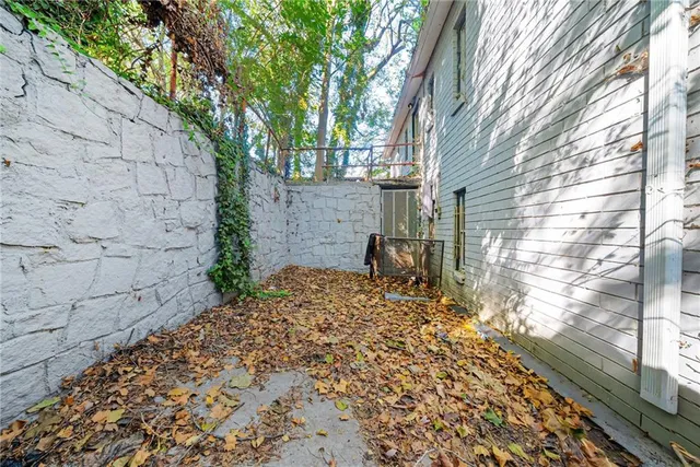 a view of a backyard with a large tree