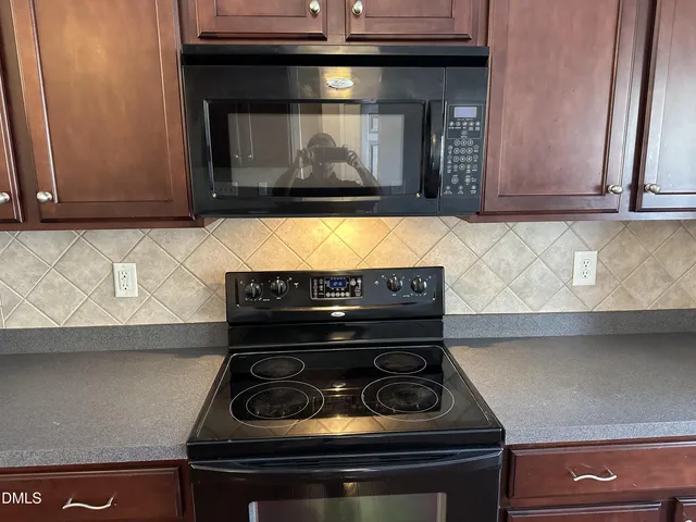 a kitchen with a stove and a microwave