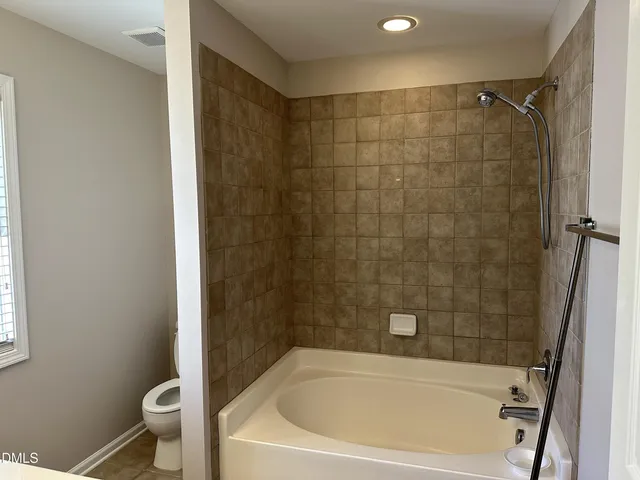 a bathroom with a shower and a toilet