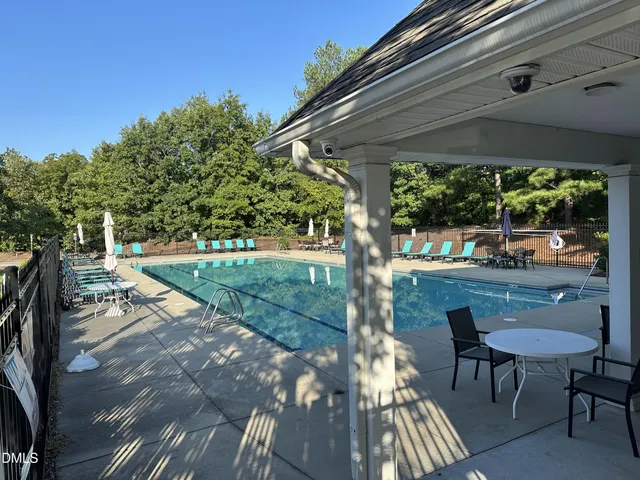 a view of yard from deck with patio