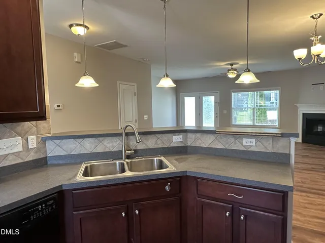 a kitchen with a sink a counter space and a window