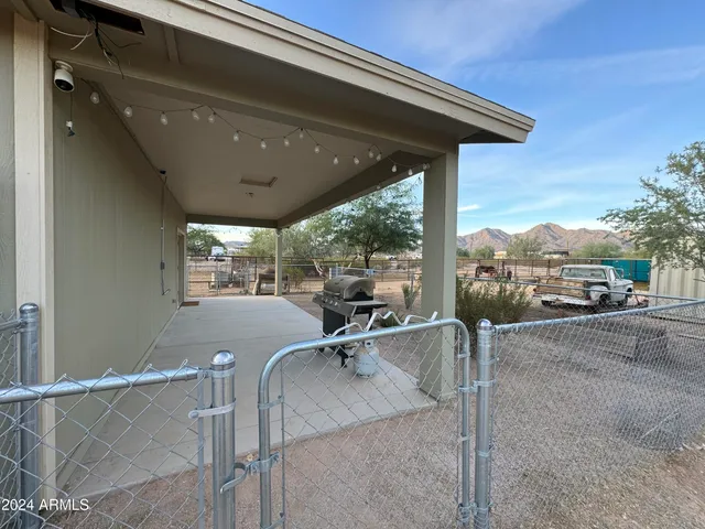 a view of a patio with a table and chairs