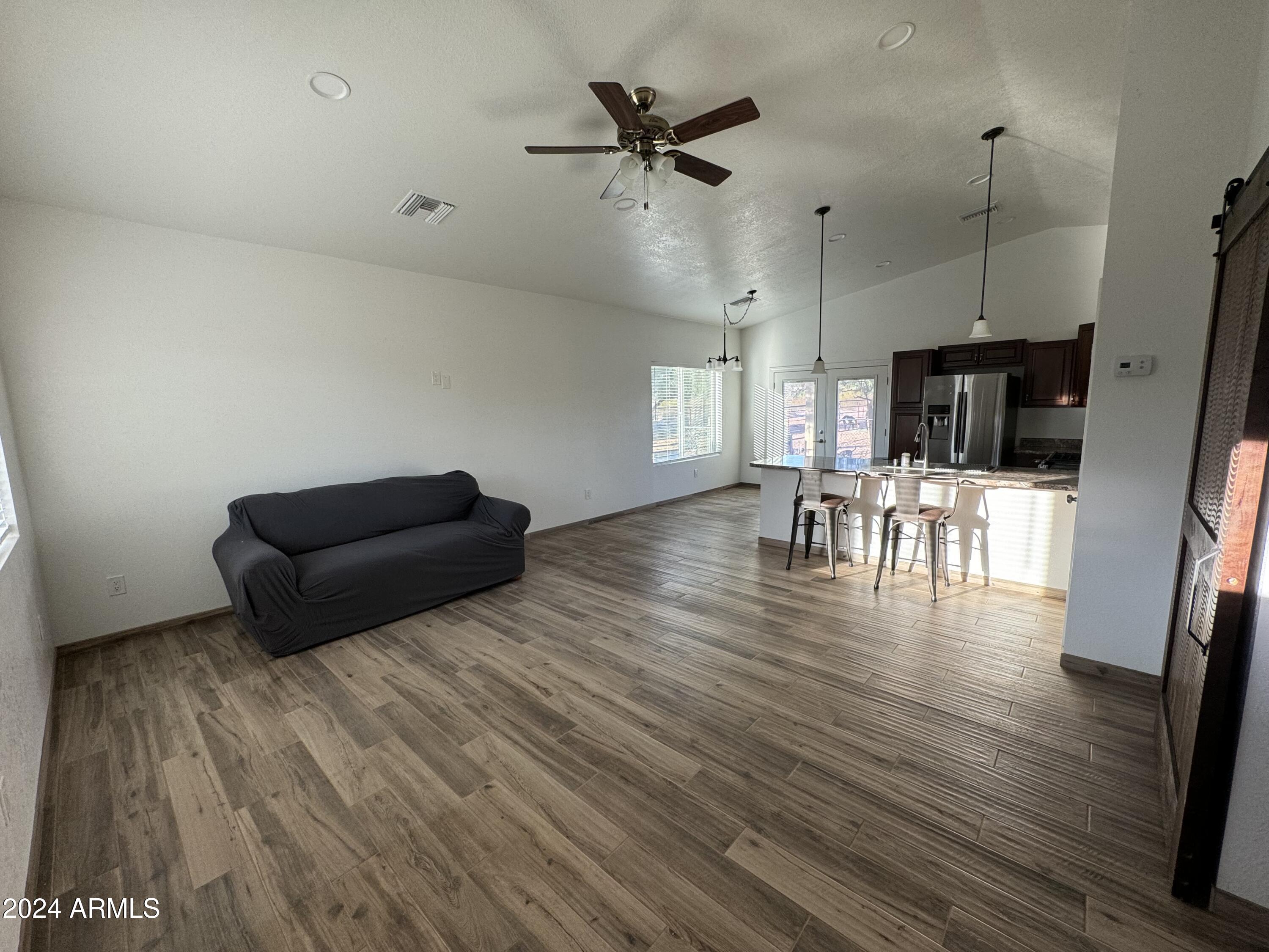 34470 North Sossaman Road San Tan Valley, AZ 85144 - Photo 5 of 12 a living room with furniture and a wooden floor