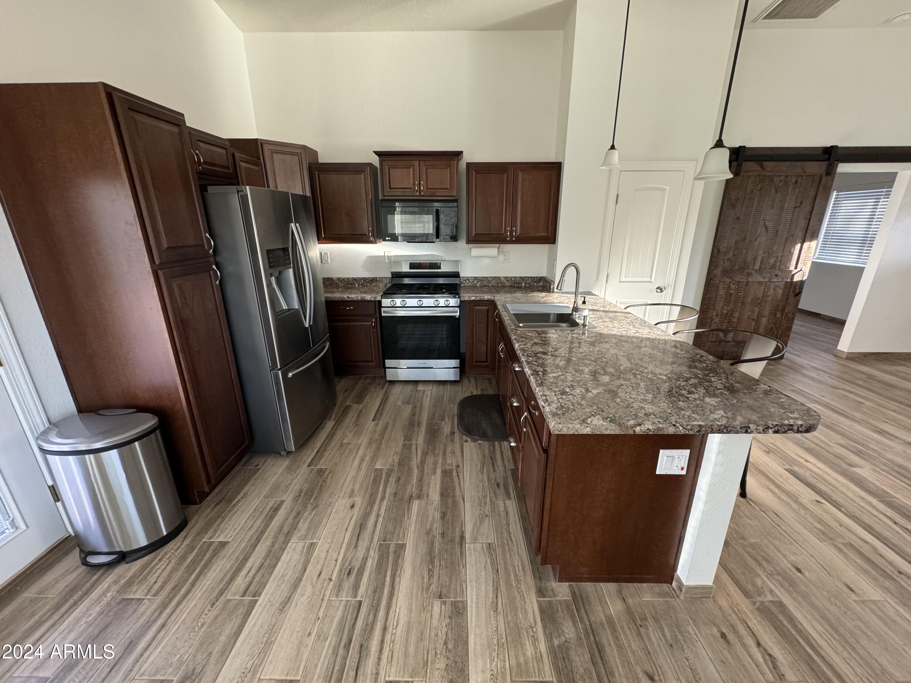 34470 North Sossaman Road San Tan Valley, AZ 85144 - Photo 6 of 12 a kitchen with refrigerator and window