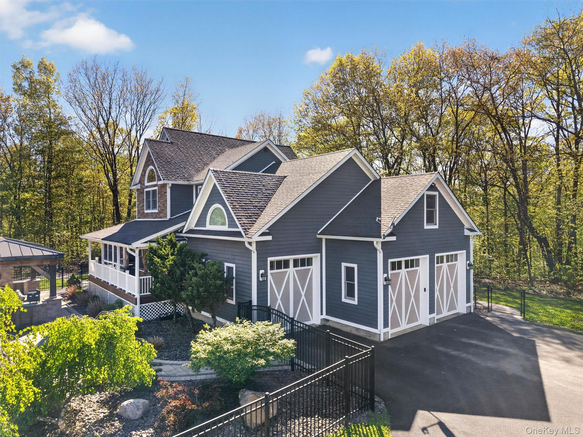 2 White Horse Road Middletown, NY 10940 - Photo 5 of 47 The sweeping driveway leads to an impressive three-bay garage, fully equipped with heating and air conditioning for year-round climate-controlled storage or workshop use.