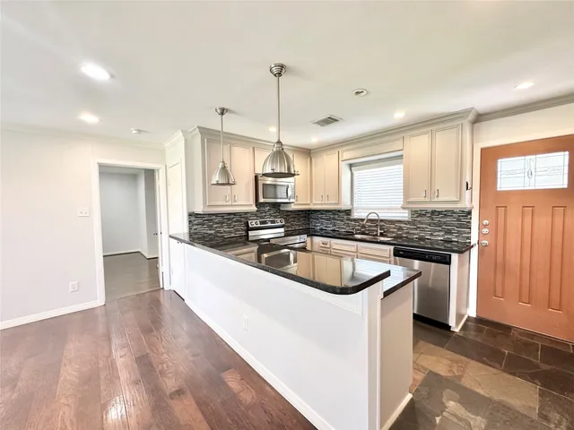 a kitchen with a sink stove and cabinets
