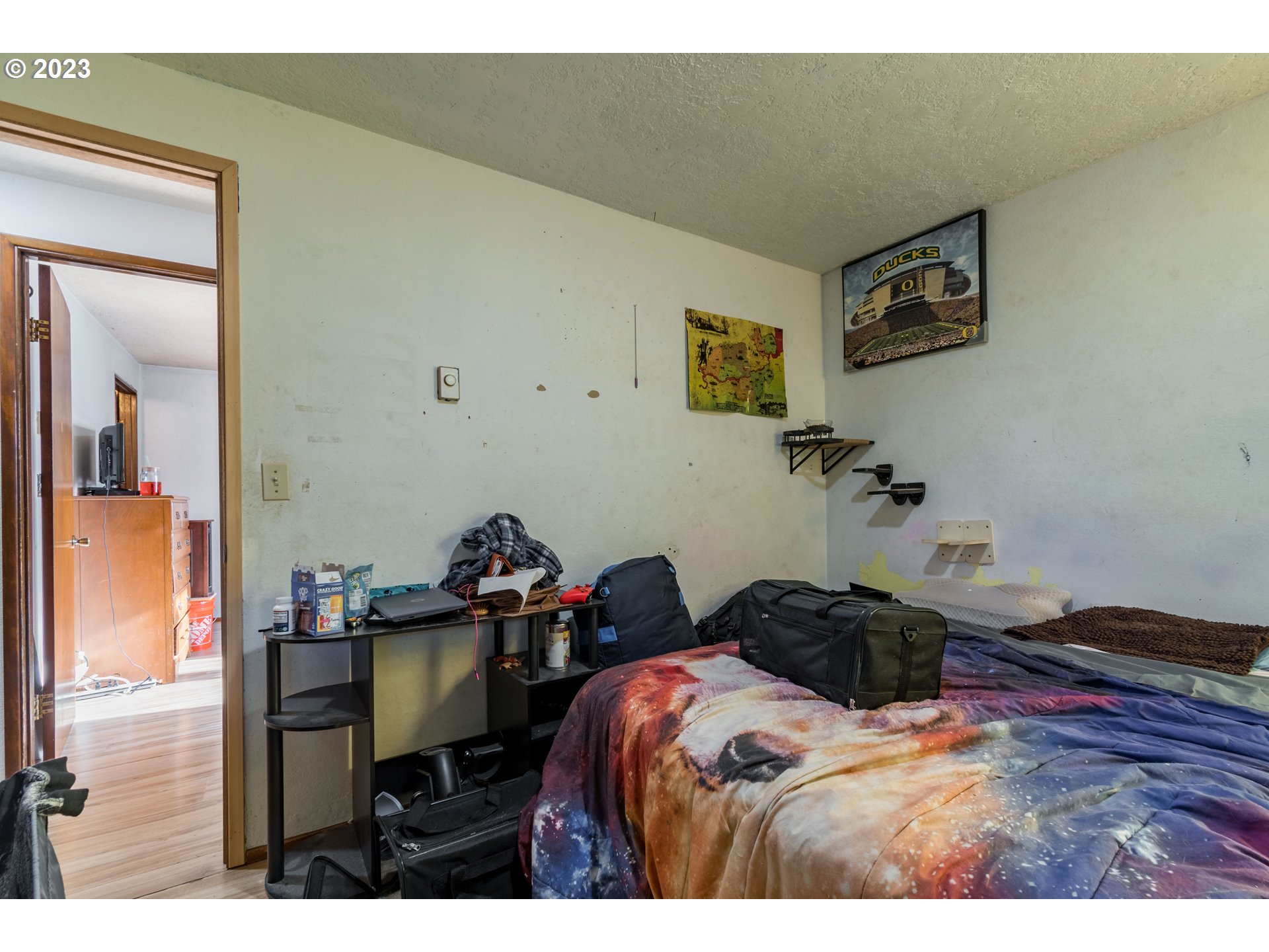 300 S Street Springfield, OR 97477 - Photo 14 of 26 a bedroom with a bed and a table in it