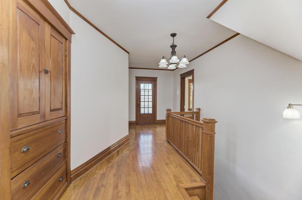8611 Archer Avenue Willow Springs, IL 60480 - Photo 19 of 37 a view of a hallway with wooden floor and staircase