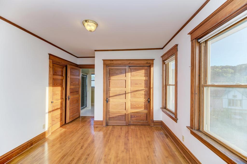 8611 Archer Avenue Willow Springs, IL 60480 - Photo 22 of 37 a view of an empty room with wooden floor and a window