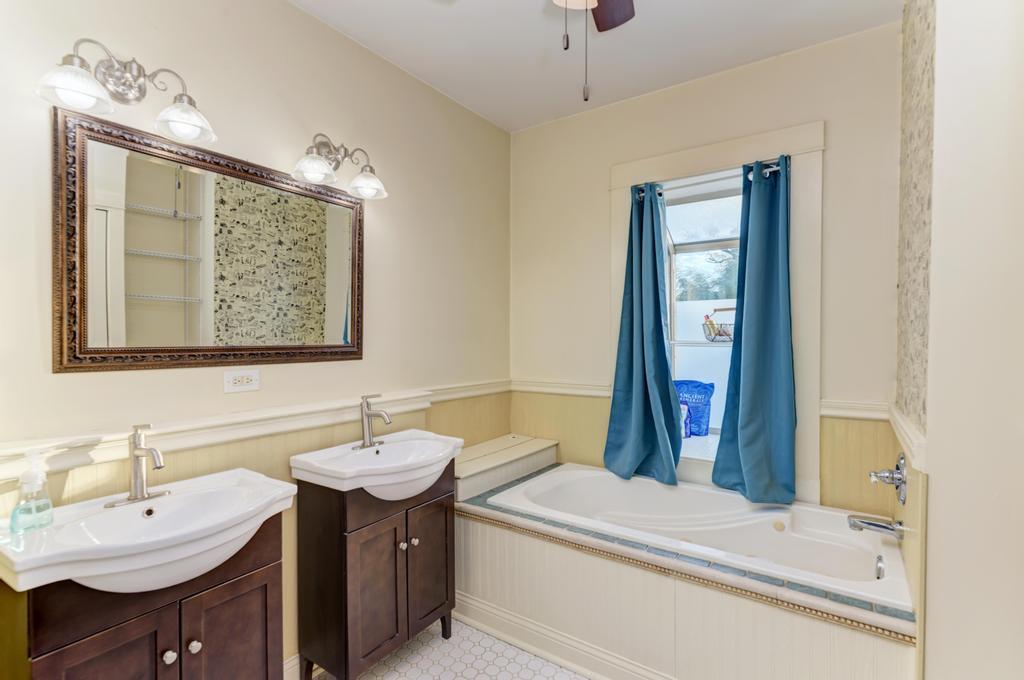 8611 Archer Avenue Willow Springs, IL 60480 - Photo 23 of 37 a bathroom with a sink and a mirror