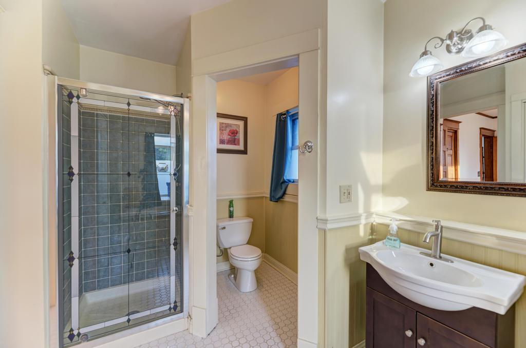 8611 Archer Avenue Willow Springs, IL 60480 - Photo 24 of 37 a bathroom with a sink a toilet and shower
