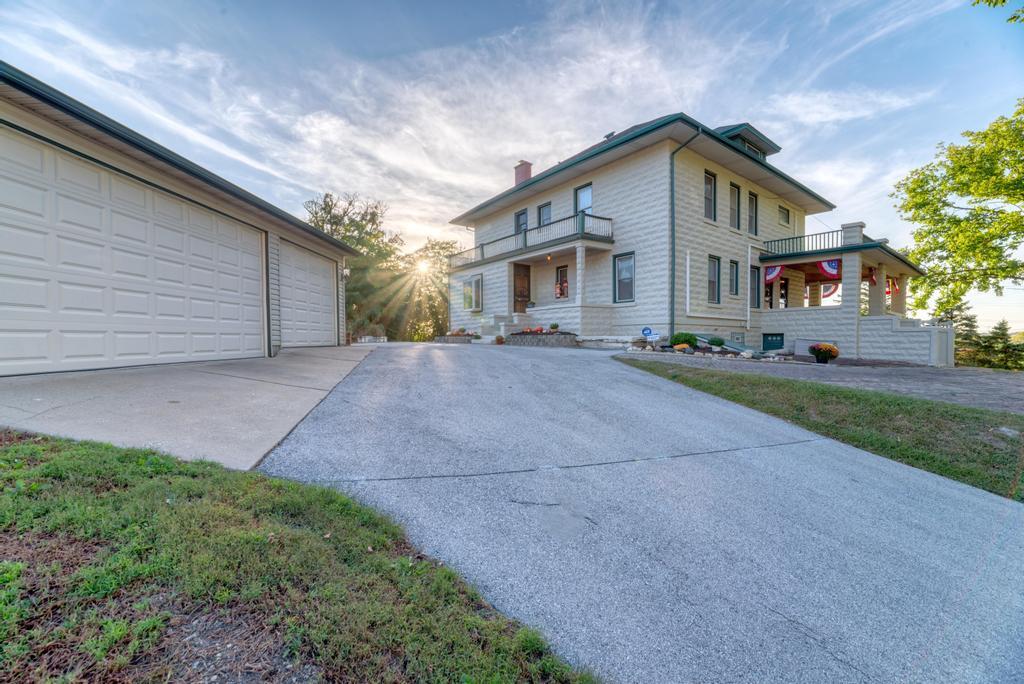 8611 Archer Avenue Willow Springs, IL 60480 - Photo 31 of 37 a front view of a house with a yard and garage