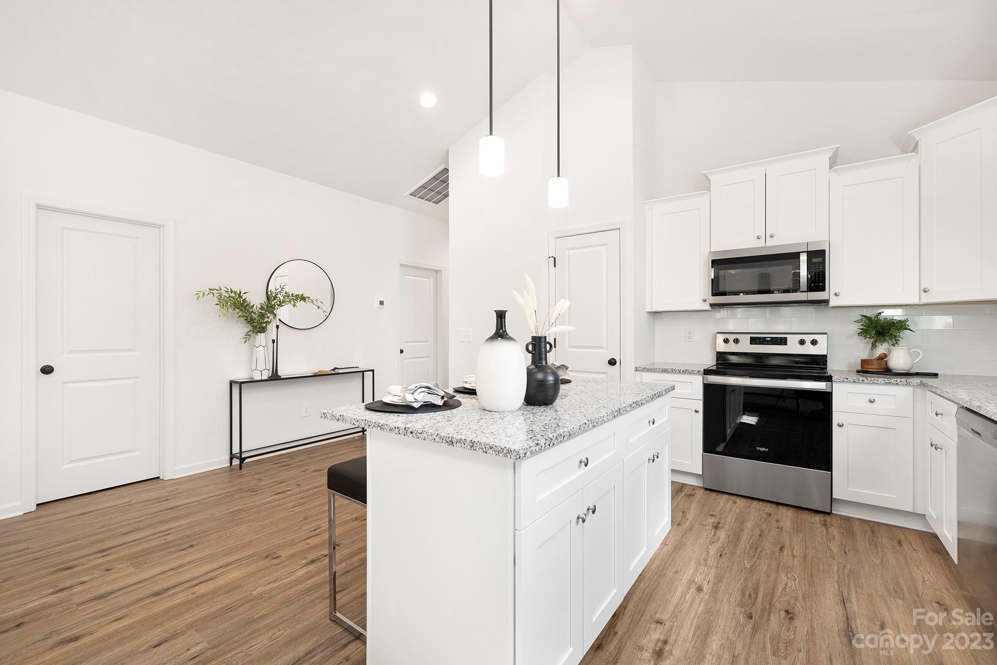 841 McDonald Road Charlotte, NC 28214 - Photo 5 of 16 a kitchen with stainless steel appliances kitchen island granite countertop a sink a stove top oven a chimney and a center island
