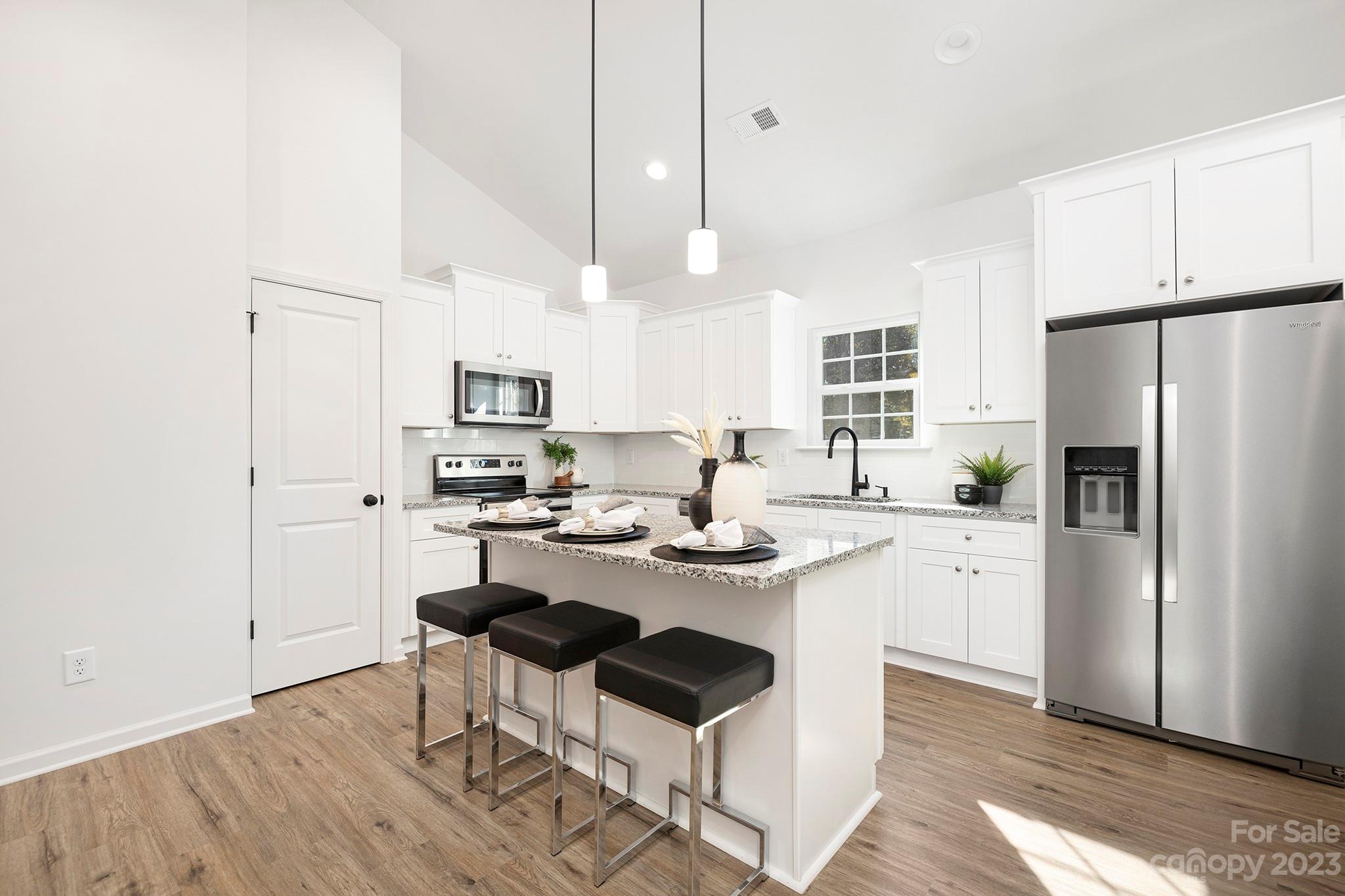 841 McDonald Road Charlotte, NC 28214 - Photo 6 of 16 a kitchen with white cabinets and stainless steel appliances