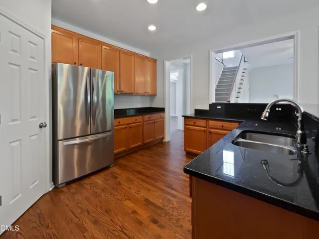 a kitchen with a refrigerator sink and stove