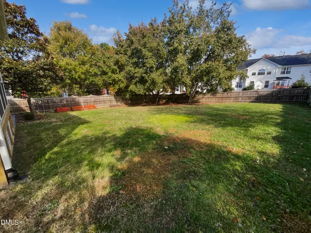 a view of yard with swimming pool and green space