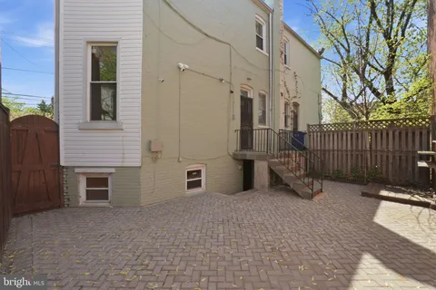 a view of a house with a wooden fence