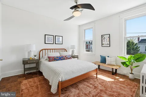 a bedroom with a bed and a window