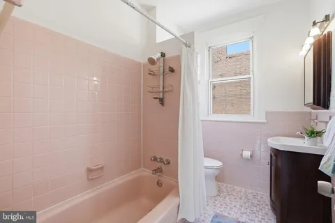 a bathroom with a sink a mirror and a window