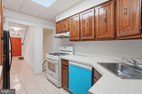 a kitchen with stainless steel appliances granite countertop a refrigerator stove and sink