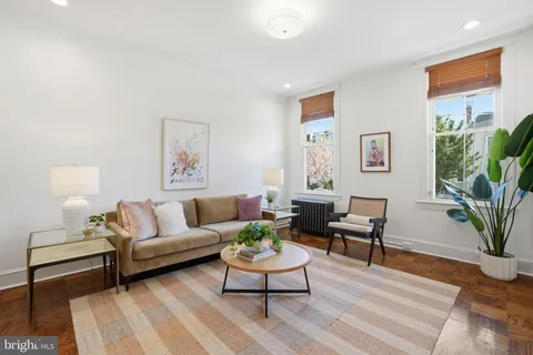 a living room with furniture potted plant and window