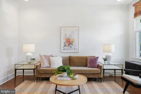 a living room with furniture a rug and a lamp