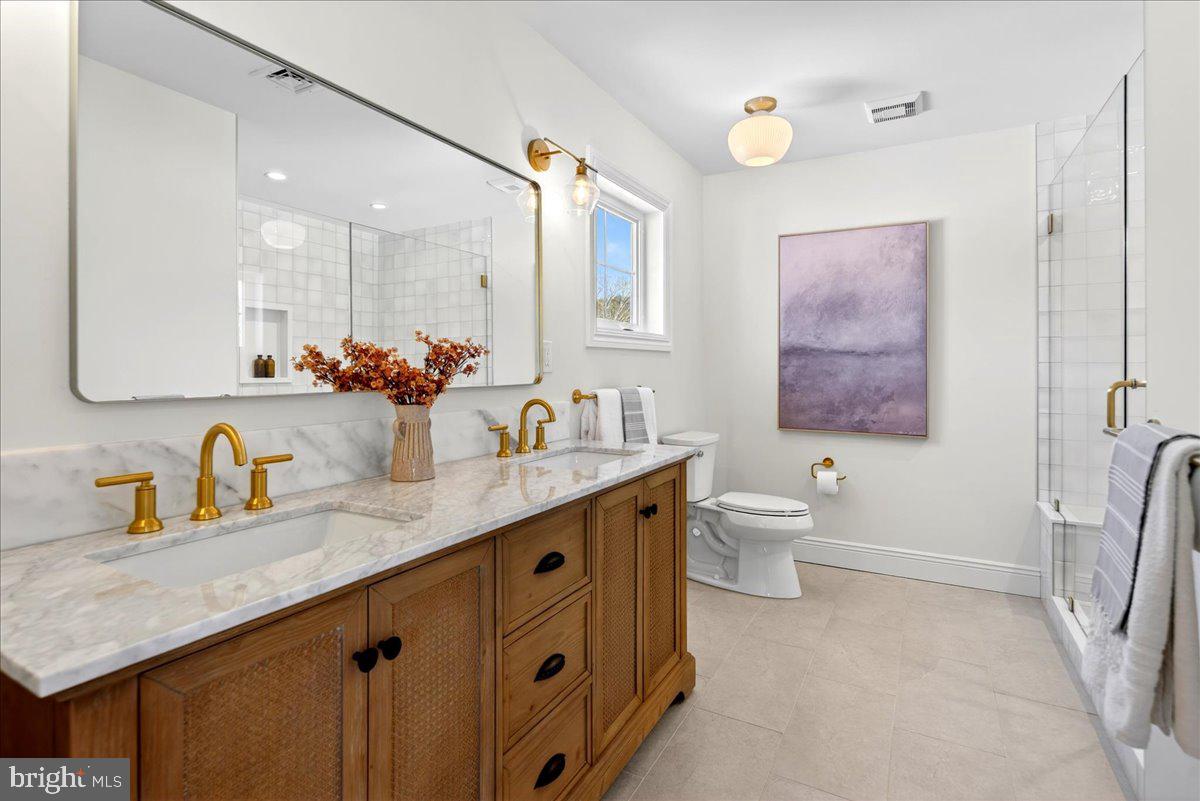 159 Byram Lane Stockton, NJ 08559 - Photo 39 of 62 a bathroom with a double vanity sink toilet mirror and bathtub