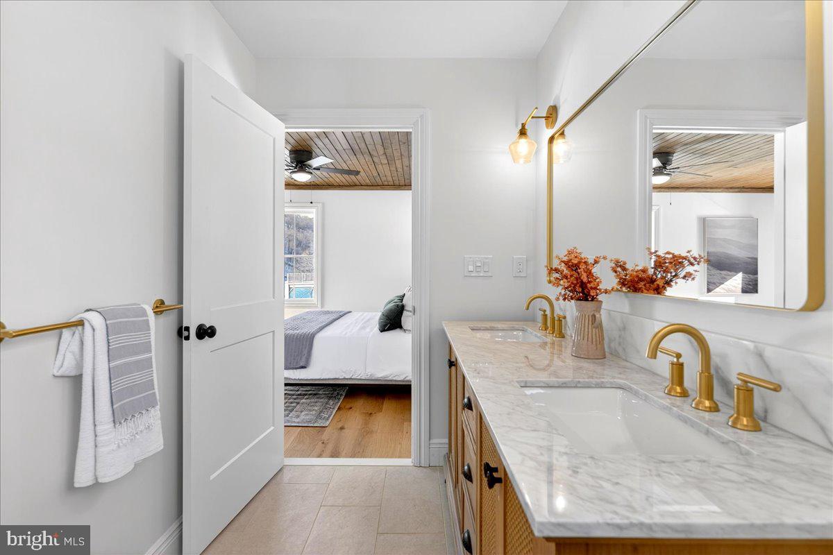 159 Byram Lane Stockton, NJ 08559 - Photo 40 of 62 a en suite bathroom with a granite countertop sink and a mirror